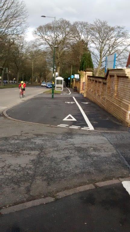 Giveway lines on a cycle lane on the pavement.