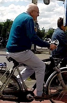 Elderly man cycling in the Netherlands