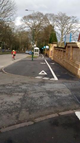 Giveway lines on a cycle lane on the pavement.