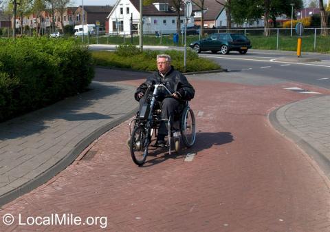 Hand cycle attachment in use on a wheelchair in the Netherlands