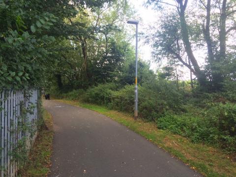 A wide lane with lighting leading to Diglis Bridge