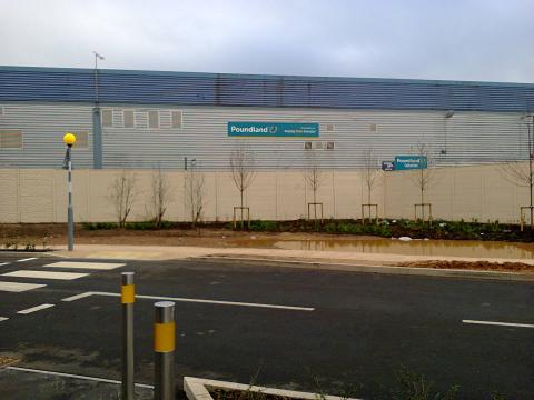 A huge wall prevents people from walking the short distance from Sainsbury's to Poundland