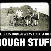 Old photo of British cycle riders on a mountain top.
