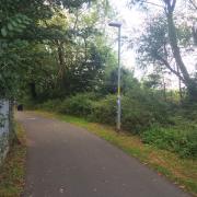 A wide lane with lighting leading to Diglis Bridge