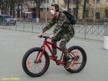 Random guy on a bike wearing a mask