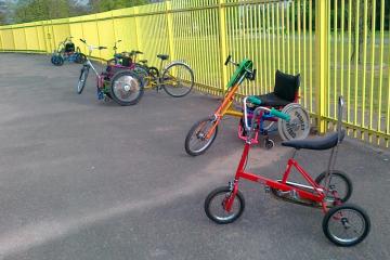 A selection of adapted cycles, with a Raleigh Chopper style tricycle in the foreground